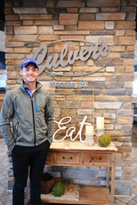 Man standing next to Culver's sign.