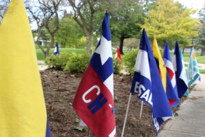 Flags of hispanic countries stuck in the ground outside the A building for Hispanic Heritage Month