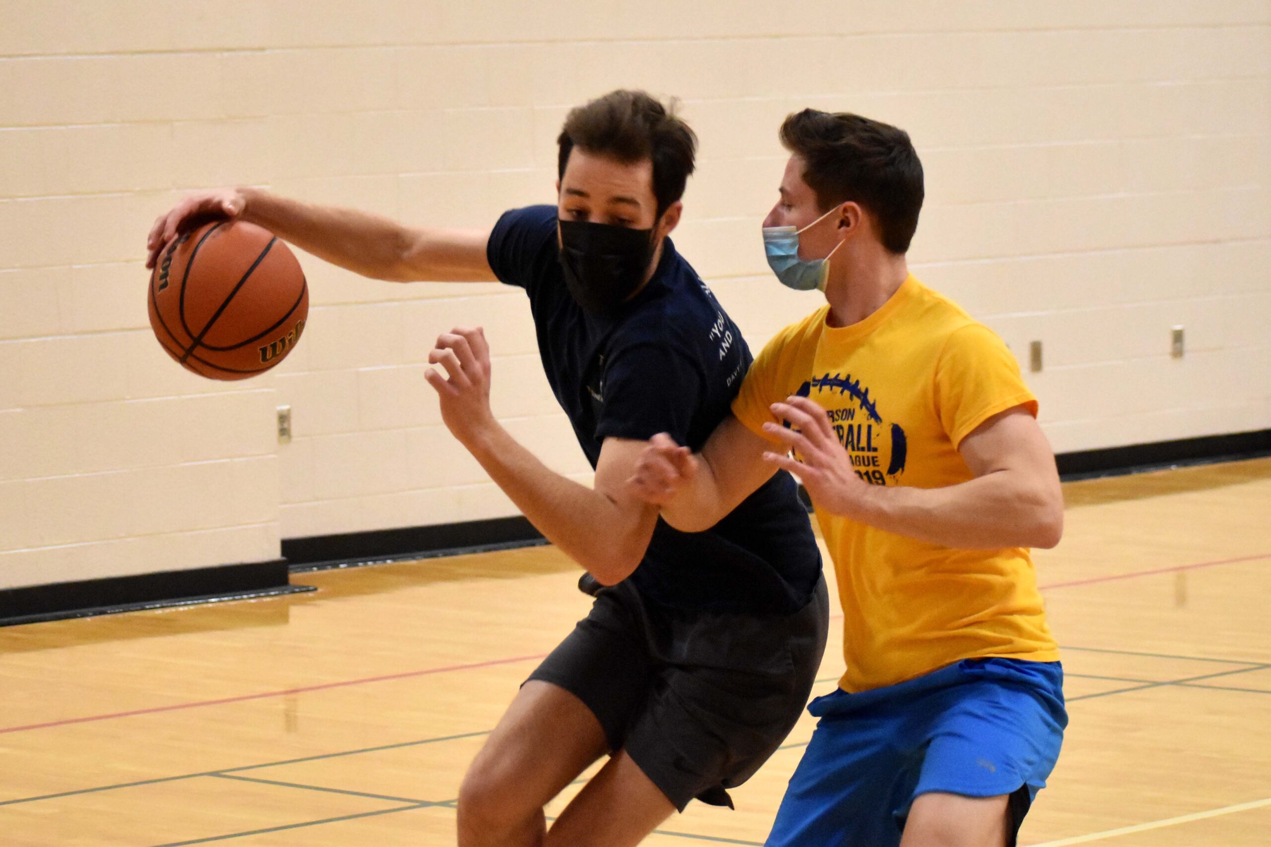 guy dribbling with someone guarding him
