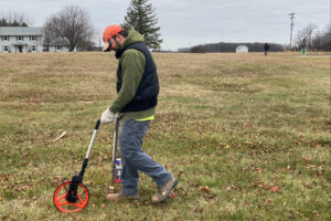 Adam Darkow surveying ground at Potter's Field